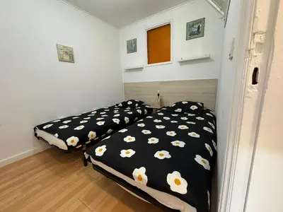 two beds in a room with black and white sheets at Oporto Perfect Days - Downtown in Porto