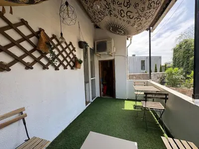 an outdoor patio with chairs and a table and green floor at Oporto Perfect Days - Downtown in Porto