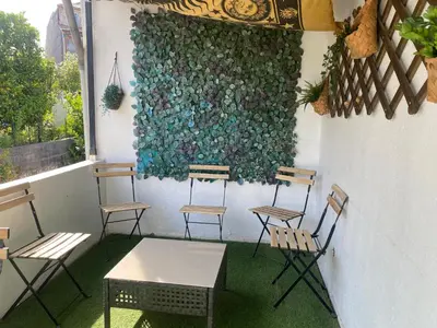 a group of chairs and a table in front of a wall at Oporto Perfect Days - Downtown in Porto