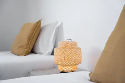 a lamp sitting on a table next to a bed at GuestReady - Lovely home with river view in Vila Nova de Gaia