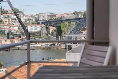 a view of a river with a bridge and buildings at GuestReady - Lovely home with river view in Vila Nova de Gaia