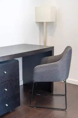 a desk with a chair next to a dresser at Spacious 2BR en suite, downtown Porto in Porto