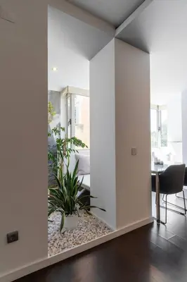a living room with white walls and plants in it at Spacious 2BR en suite, downtown Porto in Porto