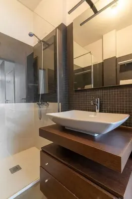 a bathroom with a white sink and a shower at Spacious 2BR en suite, downtown Porto in Porto