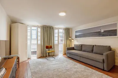 a living room with a bed and a couch at Charming Apartment by Hosty in Porto