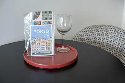a red table with a wine glass and a book at GuestReady – A welcoming space to unwind in Porto