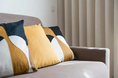 a couch with two pillows on top of it at Panorama Apartments Santa Catharina Porto in Porto