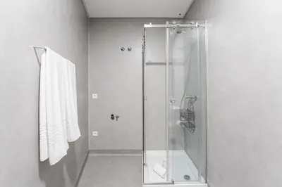 a shower with a glass door in a bathroom at Panorama Apartments Santa Catharina Porto in Porto