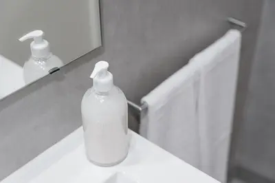 a soap dispenser on a bathroom sink in front of a mirror at Panorama Apartments Santa Catharina Porto in Porto