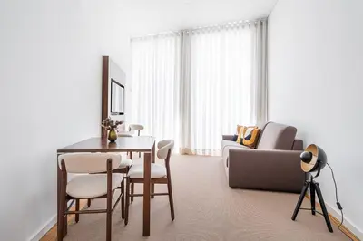 a living room with a table and a couch at Panorama Apartments Santa Catharina Porto in Porto