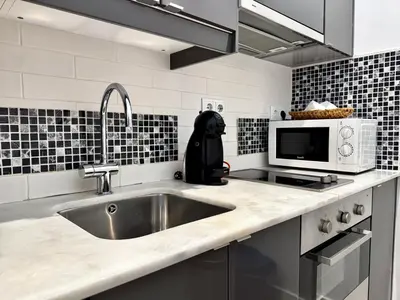 a kitchen with a sink and a microwave at Sounds of Porto 424 - Bolhão & Tradition in Porto