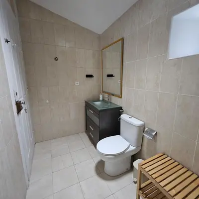 a bathroom with a toilet and a sink and a mirror at Monte Lapa 38 in Porto