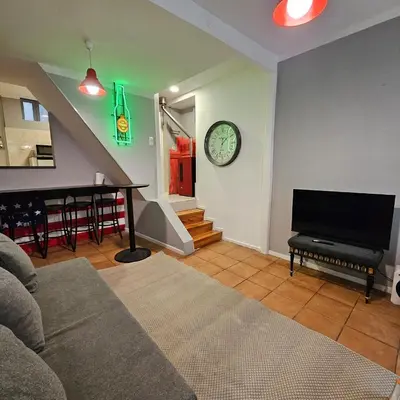 a living room with a couch and a clock on the wall at Monte Lapa 38 in Porto