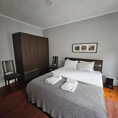 a bedroom with a bed with two towels on it at Monte Lapa 38 in Porto