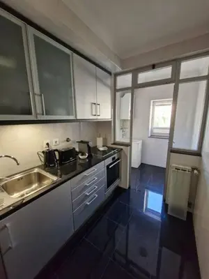 a kitchen with a sink and a counter top at Oliveira Charm-Porto in Porto