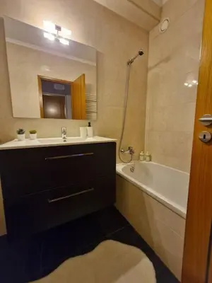 a bathroom with a sink and a tub and a mirror at Oliveira Charm-Porto in Porto