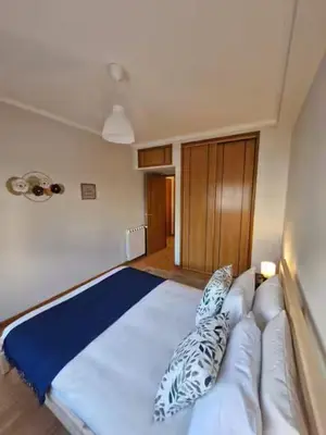 a bedroom with a large white bed with pillows on it at Oliveira Charm-Porto in Porto