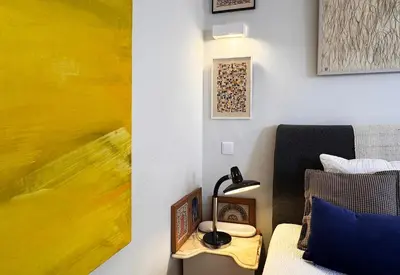 a room with a bed and a lamp on a table at Caligrafia - Artistic Studio in Porto