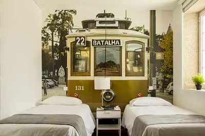 a room with two beds and a trolley car at Clerigos View in Porto