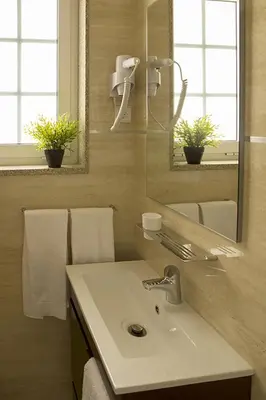 a bathroom with a sink and a mirror and towels at Clerigos View in Porto