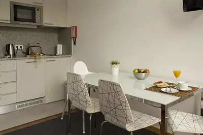 a kitchen with a white table and chairs at Clerigos View in Porto