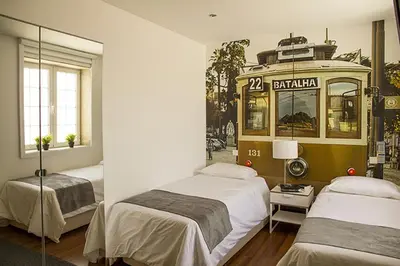 a room with two beds and a bus at Clerigos View in Porto