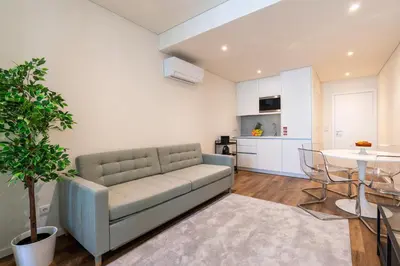 a living room with a couch and a tv on a wall at Host Wise - Marquesa Palace in Porto