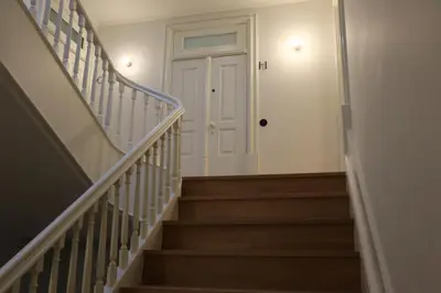 a hallway with stairs with a white door at Fernandes Tomás Apartments 797 in Porto
