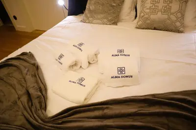 a bed with towels and pillows on it at Fernandes Tomás Apartments 797 in Porto