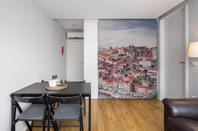 a dining room with a wall mural of a city at Trindade Duo Apartments in Porto