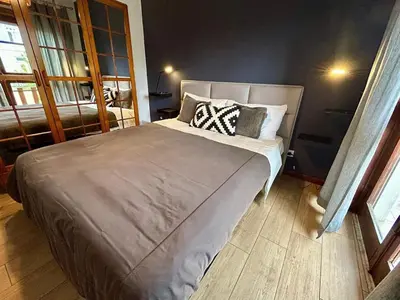 a bedroom with a large bed with pillows on it at Douro Exclusive View in Vila Nova de Gaia