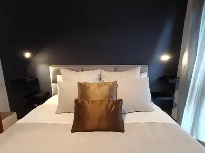 a bedroom with a bed with white sheets and pillows at Douro Exclusive View in Vila Nova de Gaia