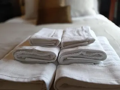 a pile of towels sitting on top of a bed at Douro Exclusive View in Vila Nova de Gaia