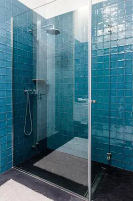 a blue tiled shower with a glass door at Oportolazaro Premium Downtown Porto in Porto