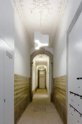 a hallway with a ceiling with a chandelier at Oportolazaro Premium Downtown Porto in Porto