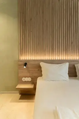 a bedroom with a large bed with a wooden headboard at ORM - Santa Teresa Apartments in Porto