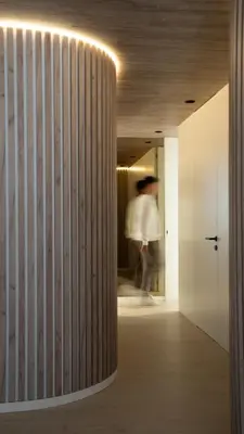 a person is walking through a hallway with a column at ORM - Santa Teresa Apartments in Porto