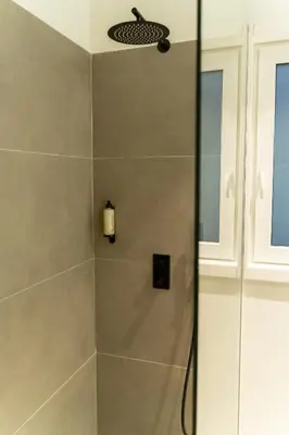 a shower stall with a glass door in a bathroom at ORM - Santa Teresa Apartments in Porto