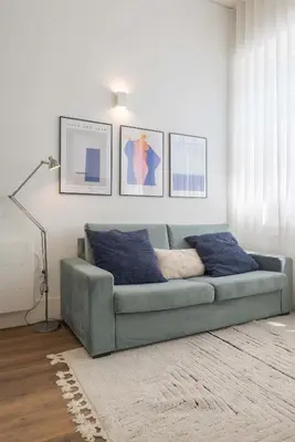 a living room with a blue couch in a room at Liiiving in Porto - Urban Retreat Apartment in Porto