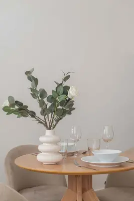 a table with a white vase with flowers on it at Liiiving in Porto - Urban Retreat Apartment in Porto