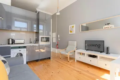 a bedroom with a white bed and a white cabinet at Liiiving in Porto - Silver Light Apartment in Porto