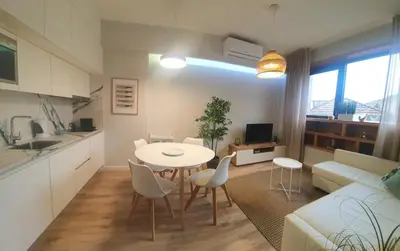 a kitchen and living room with a table and chairs at Charming Apartment in the Heart of Historic Porto in Porto