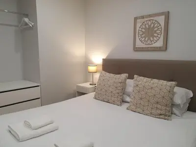 a bedroom with a large white bed with two pillows at Charming Apartment in the Heart of Historic Porto in Porto
