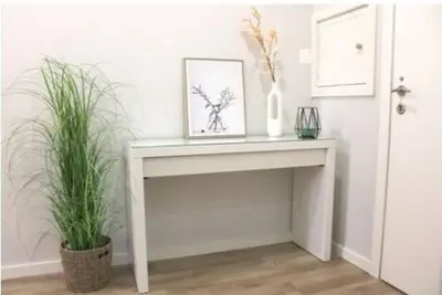 a white table with a picture and two plants on it at Charming Apartment in the Heart of Historic Porto in Porto