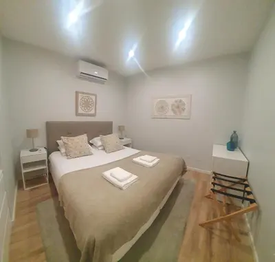 a bedroom with a bed with two towels on it at Charming Apartment in the Heart of Historic Porto in Porto