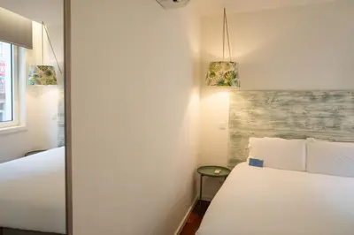 a bedroom with two beds and two lights at Oporto Riverside Rooftop in Porto
