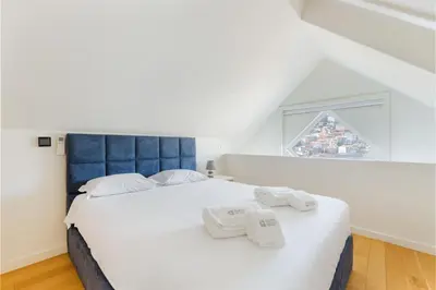 a bedroom with a large bed with towels on it at GuestReady - Douro Nest Apartments in Vila Nova de Gaia