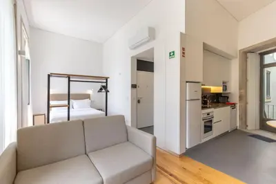 a living room with a couch and a bedroom at Filigrana Apartments in Porto