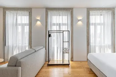 a living room with a bed and a couch at Filigrana Apartments in Porto