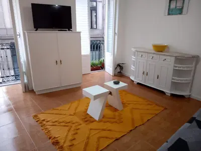 a living room with white furniture and a flat screen tv at Nice Belmonte Flat in Porto